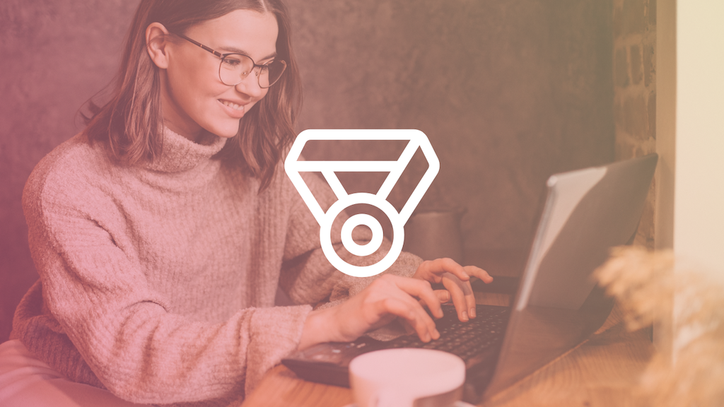 woman at laptop with a medal icon