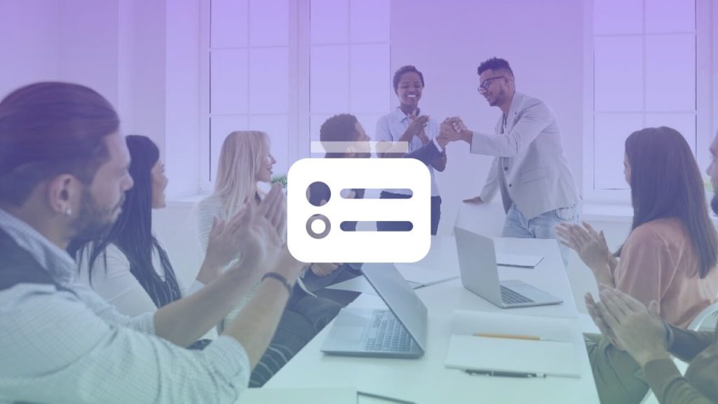 people clapping a person in conference room with laptops