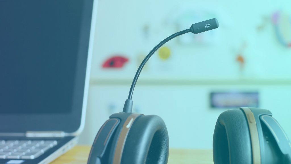 A headset next to a laptop. The kind of station that remote workers have in their home of shared office space. Where they would take employee engagement surveys